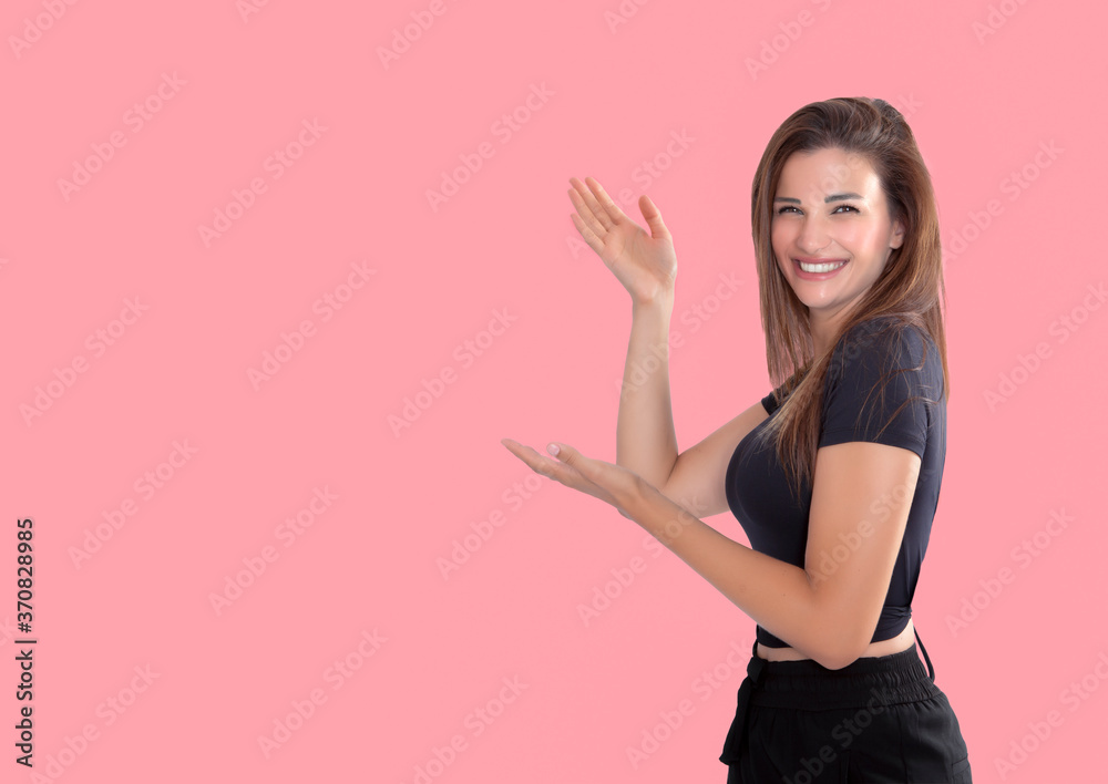 Beautiful young woman on pastel pink background