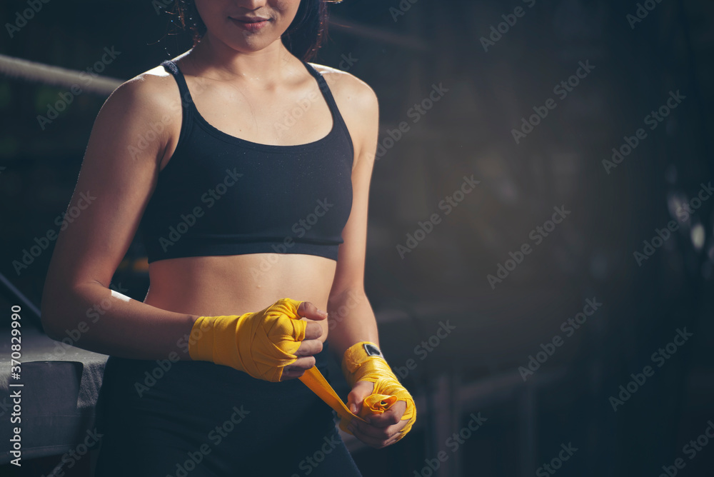 Fit Female strap on her wrist and exercise hard to strengthen muscle