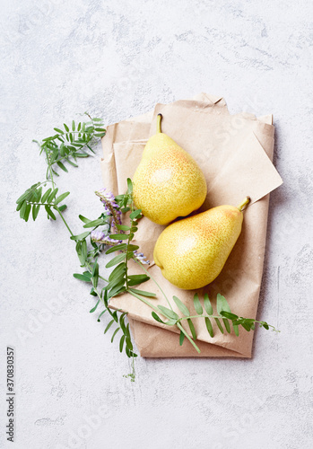 Fresh yellow pears with wild flowers viewed from above photo