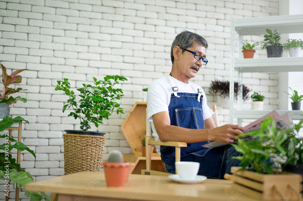 An elderly man is relaxing with coffee and reading Newspaper at his home . An elderly man is relaxing with coffee and reading Newspaper at his home .