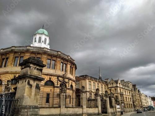 The historic University of Oxford Sheldonian theatre and buildings of Broad Street under a stormy sky. photo