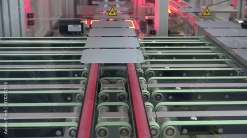 Silicon Solar Wafers Exiting Infrared Belt Furnace After Metallization Firing on Automated Photovoltaic Manufacturing Line