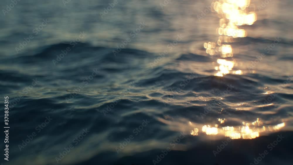 Calm sea surface close-up in slow motion in the evening. Highly detailed very realistic top quality 3d animation