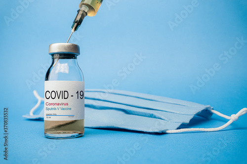 Sputnik V vaccine concept and background for Coronavirus. New vaccine sputnik-v isolated on blue background. Covid-19, 2019-nCov pandemic. photo