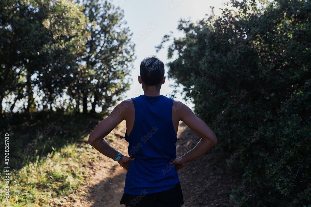 Determined man standing on nature during workout Determined man standing on nature during workout