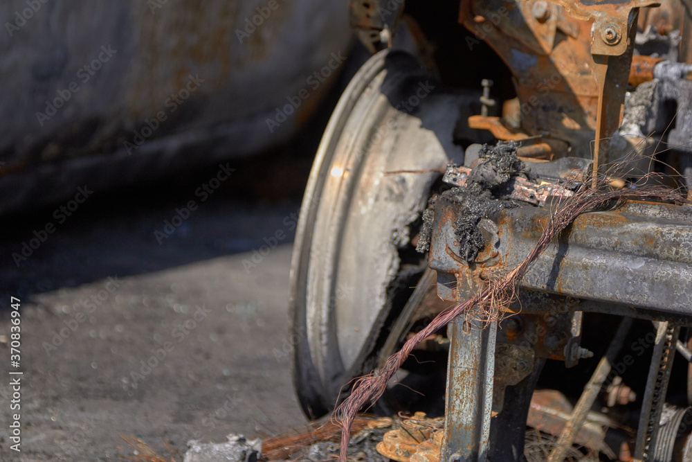 wheels and wheels of a burned-out car in one of the city's districts wheels and wheels of a burned-out car in one of the city's districts