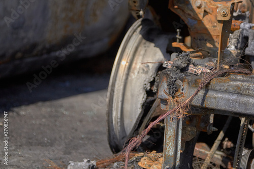 wheels and wheels of a burned-out car in one of the city's districts