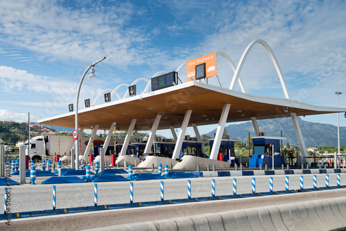Futuristic exterior of toll road with contemporary payment system on background of blue sky