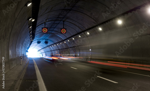 Modern road tunnel with artificial lightning and traffic light trails in long exposure