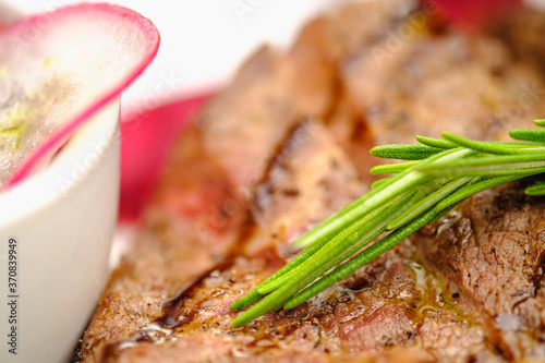 Grilled maso with vegetables and rosemary on a white plate. photo