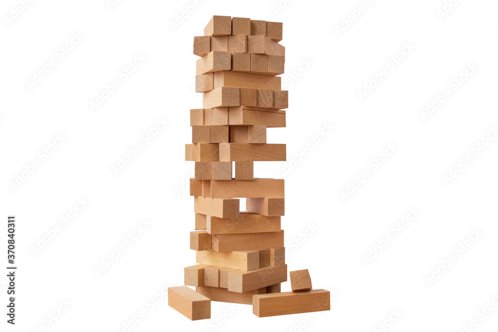 Board game Jenga Tower made of wooden blocks. A tower of unevenly shifted wooden beams. A lesson for agility, logic and coordination. Home entertainment. Balance. Close-up. Isolation, white background Board game Jenga Tower made of wooden blocks. A tower of unevenly shifted wooden beams. A lesson for agility, logic and coordination. Home entertainment. Balance. Close-up. Isolation, white background
