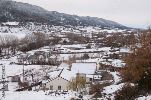 Houses and rural landscape covered with snow. Sabiñanigo Alto. Huesca. Aragon. Spain.