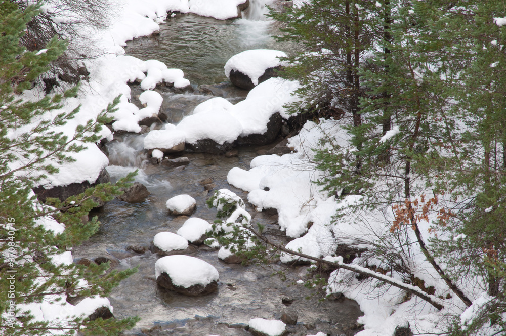 Sia River with its snow-covered banks. Pyrenees. Huesca. Aragon. Spain. Sia River with its snow-covered banks. Pyrenees. Huesca. Aragon. Spain.