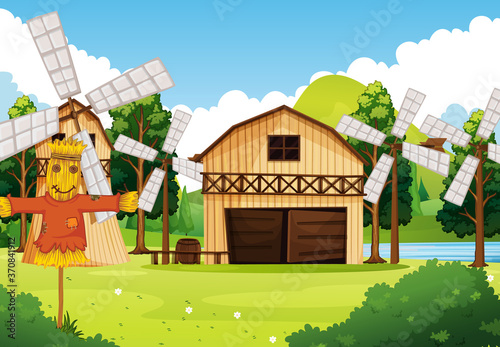 Farm in nature scene with barn and windmill and scarecrow