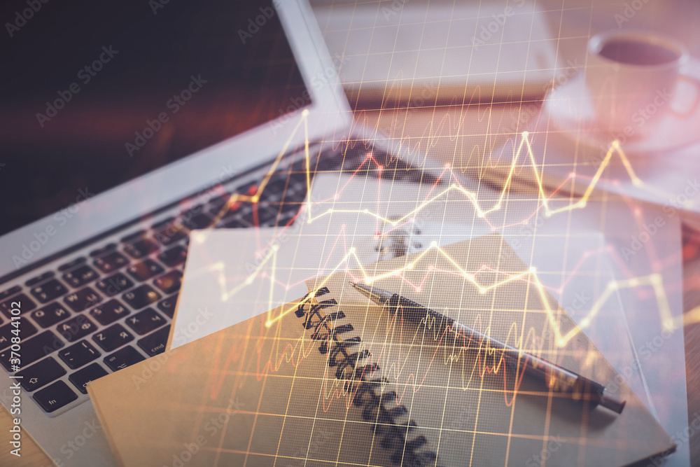 Double exposure of financial chart drawing and desktop with coffee and items on table background. Concept of forex market trading