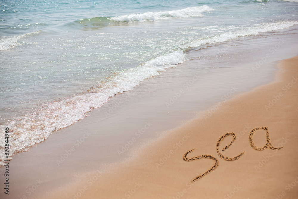 Fototapeta premium Beautiful seascape and beach. The inscription on the sea shore on the sand of the floor of the Sea.