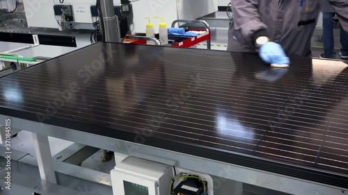 Quality Inspection and Surface Cleaning of Finished Solar Panel Module After Lamination in Photovoltaic Manufacturing Factory