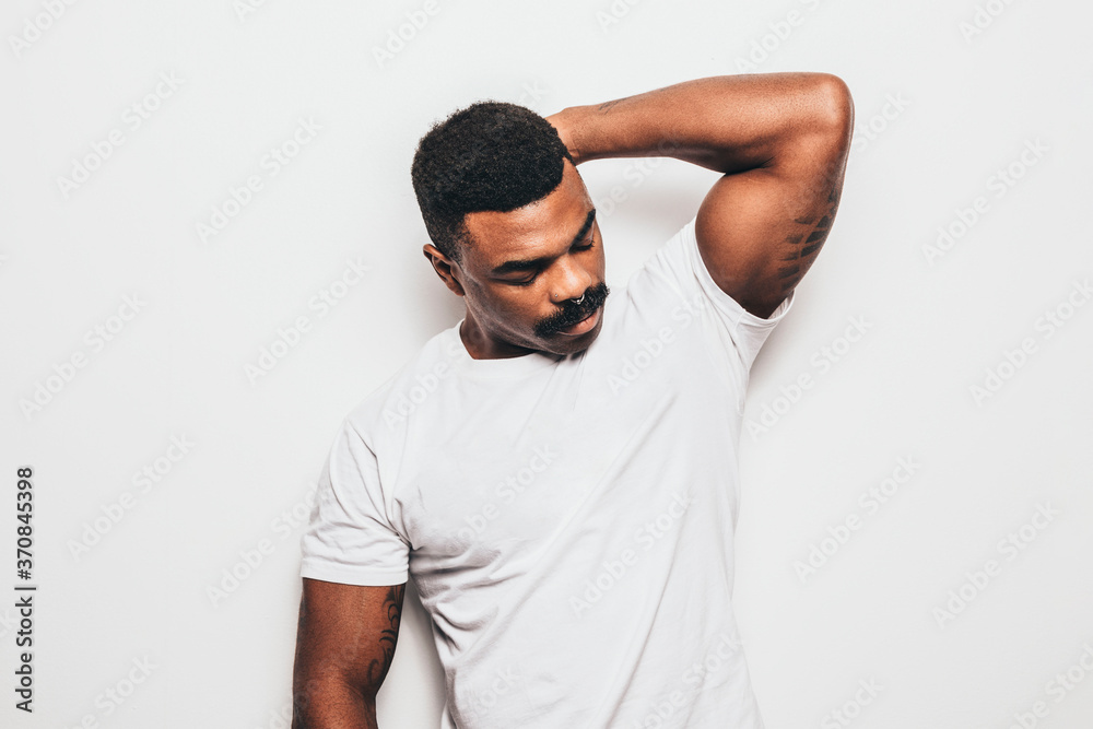 Serious black man with casual outfit posing over white background looking away Serious black man with casual outfit posing over white background looking away