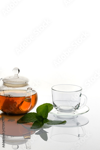 A Cup of tea with a mint branch on a white background.
