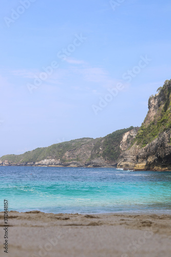 Manta Bay or Kelingking Beach on Nusa Penida Island, Bali, Indonesia. Amazing view, white sand beach with rocky mountains and azure lagoon with clear water of Indian Ocean 
