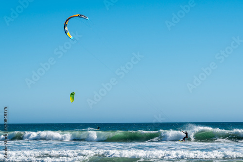 Two kite surfing in the sea
