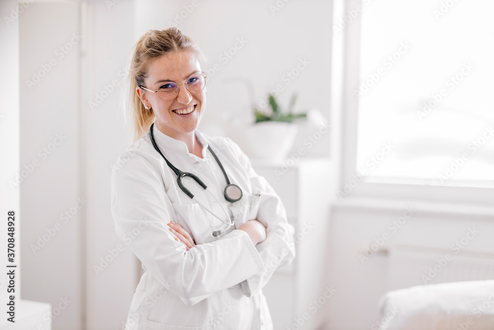 Portrait of smiling female doctor with crossed arms Portrait of smiling female doctor with crossed arms