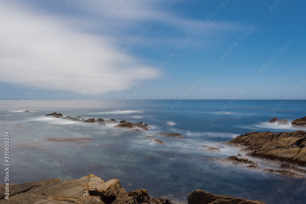 A long exposure of a rocky seashore of Pacific ocean in California.
