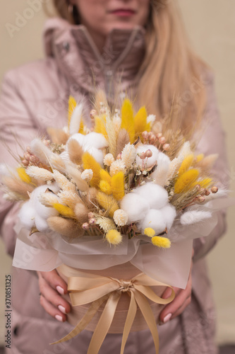 Composition of cozy flowers. Floral bouquet of flowers of cotton flowers  gypsophila  wheat and lagurus for a gift for mothers day.