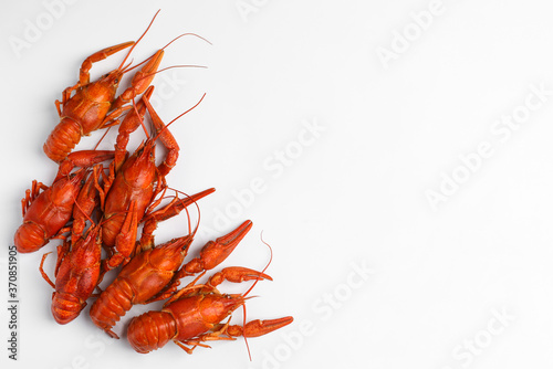Delicious boiled crayfishes isolated on white, top view
