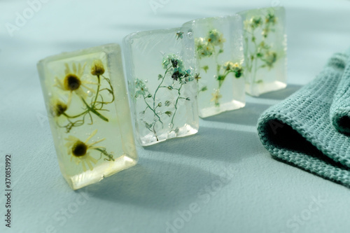 Various wildflowers cast in transparent bars of glycerine soaps photo