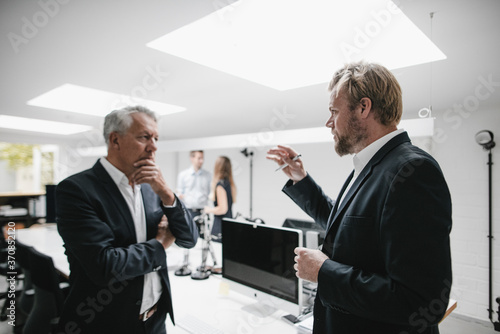 Two businessmen discussing on a meeting in office photo