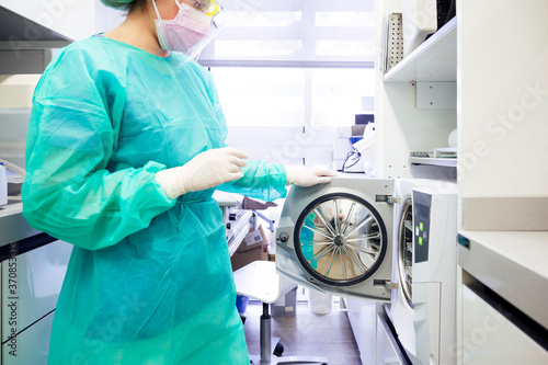 Close-up of dentist sterilizing medical instruments in clinic photo