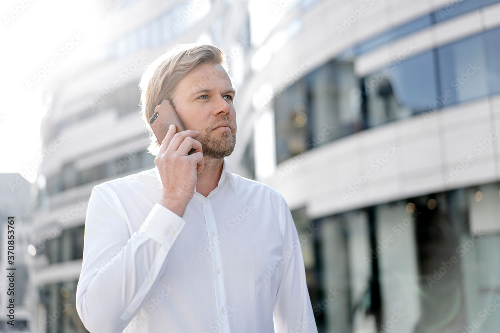 Businessman on the phone in the city Businessman on the phone in the city
