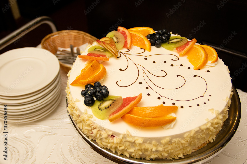 Birthday cake with berries and fruits: orange and kiwi slices. Festive catering Birthday cake with berries and fruits: orange and kiwi slices. Festive catering