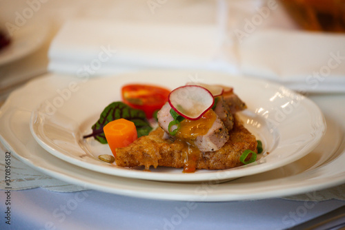 A healthy dish with meat and vegetables. Healthy food in a restaurant. Table setting with white plates