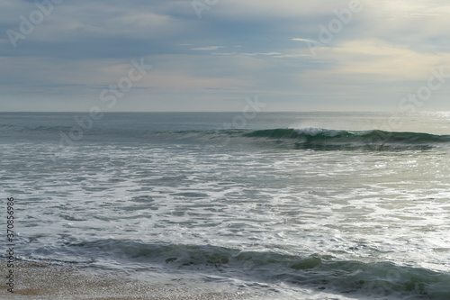 Fototapeta Naklejka Na Ścianę i Meble -  Beautiful waves and clouds over the sea. pastels tones 