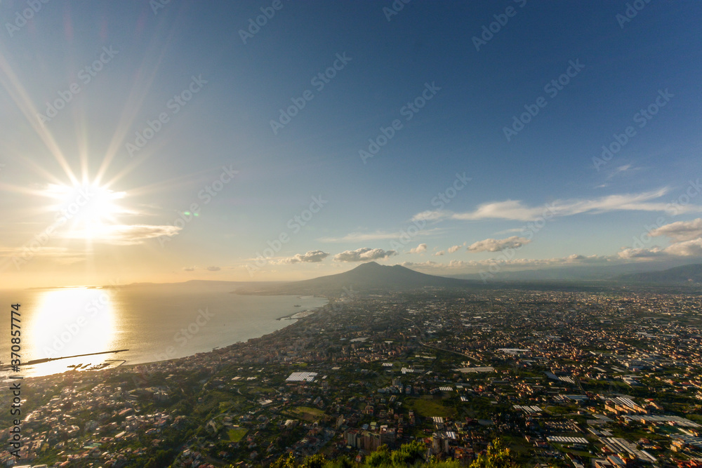 Sunset with warm light over the Gulf of Naples, With mount Vesuvius in the background, Campania region, South Italy.