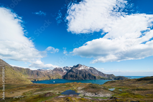 UK, South Georgia and South Sandwich Islands, Clouds over coastal landscape ofÔøΩGodthulÔøΩbay photo