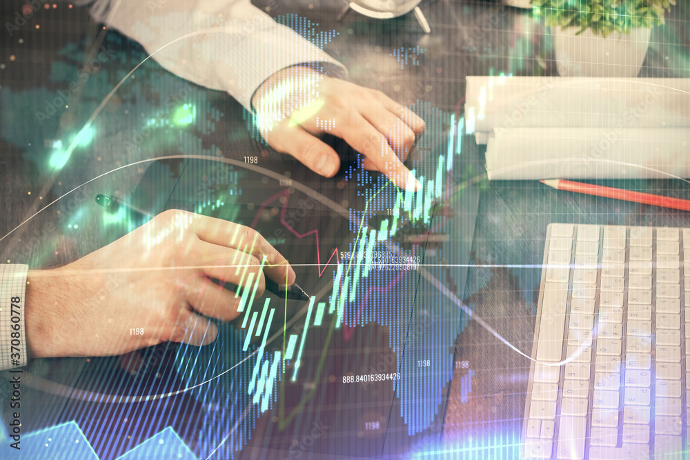 Double exposure of man's hands holding and using a phone and financial graph drawing. Analysis concept. Double exposure of man's hands holding and using a phone and financial graph drawing. Analysis concept.