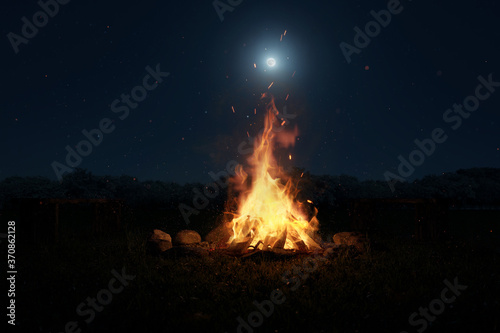 3d rendering of big bonfire with sparks and particles in front of forest and moonlight photo