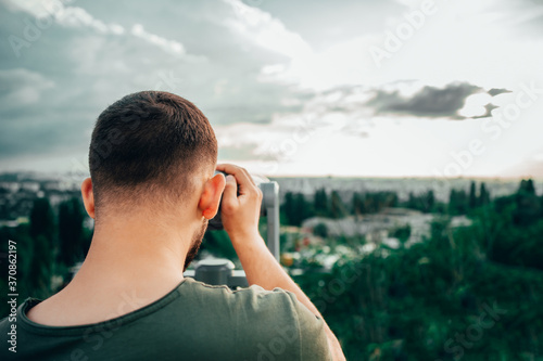 man watch in telescope 