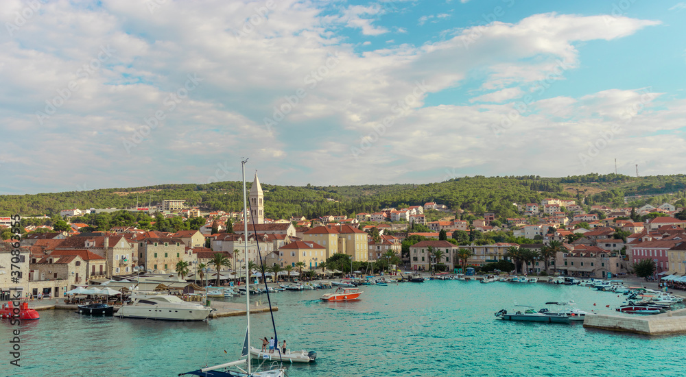 Supetar Croatia August 2020 Beautiful picturesque view of the town of Supetar, as seen from the car ferry from up high. Warm summer day on the small coastal town on the island of Brac