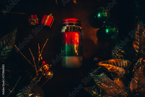 A Christmas Candle Surrounded by Various Holiday Props