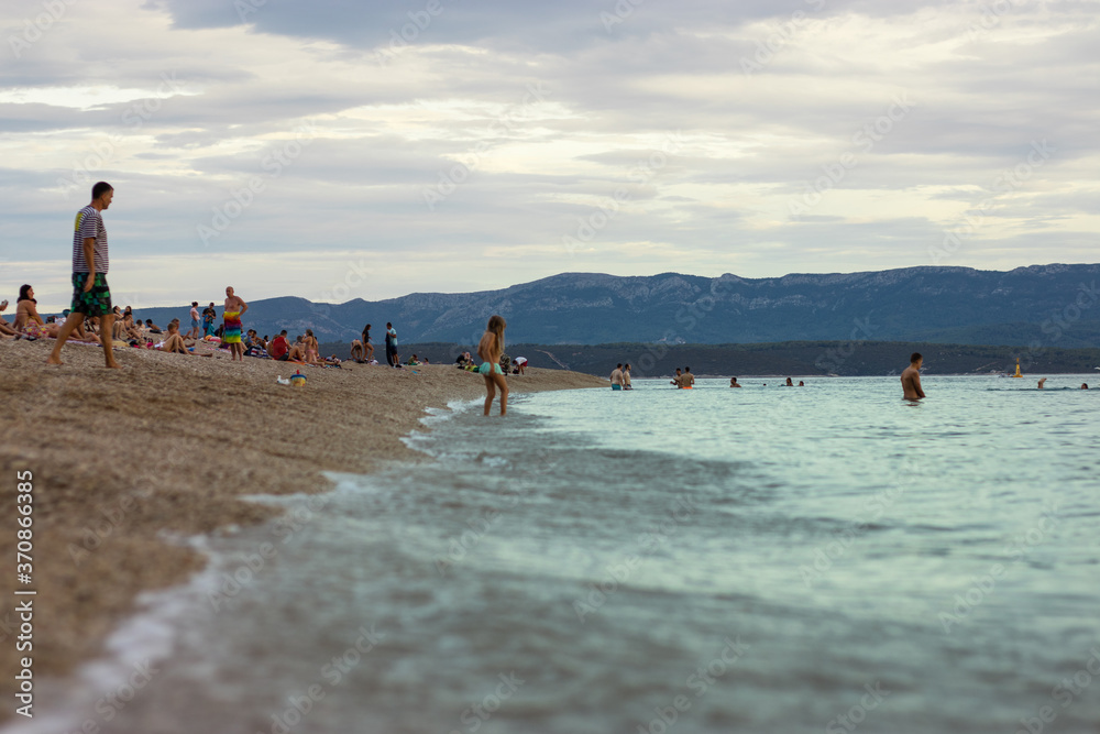 Bol Croatia, August 2020 Famous Zlatni Rat beach filled with tourists and travellers enjoying a warm summer day during the covid global pandemic outbreak