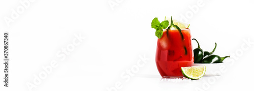 Spicy alcoholic cocktail with vodka, tomato juice, jalapeno pepper, lime and salt, white background, hard light, copy space