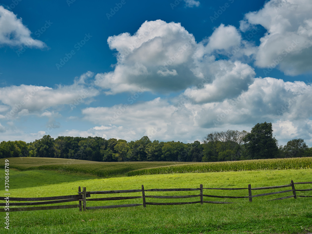 Pennsylvania Dutch country farm and cornfield surrounded by a wooden fence