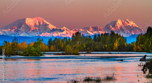 Sunrise on Mt Foraker and Mt Hunter accross the Susitna river with fall foliage.  Mount Foraker is a 17,400-foot mountain in the central Alaska Range, in Denali National Park photo