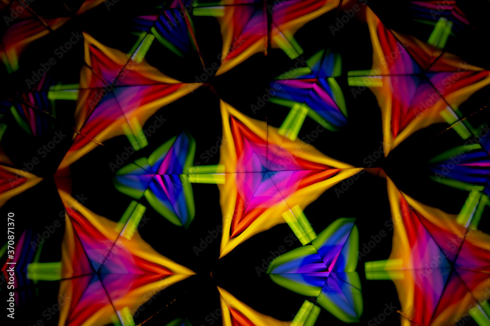 3D rendering or 3D rendering. Kaleidoscopic image. Symmetry with colored lights on a black background.
