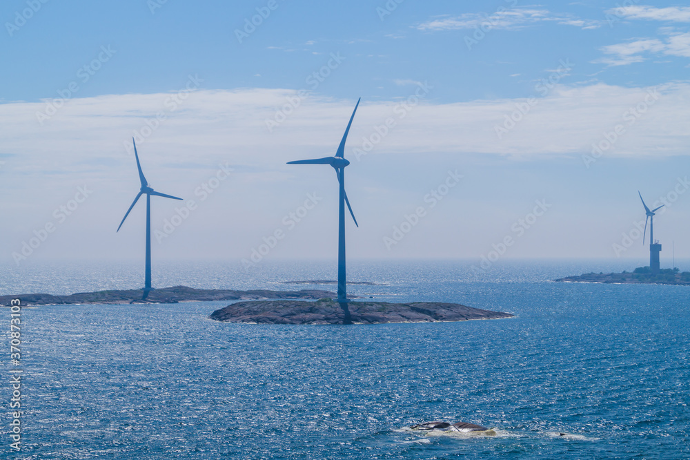 Windmill on an island in the sea. wind generator for generating electricity. renewable energy production