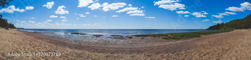 Sea shore. coastline panorama. seascape with horizon line. sky with clouds. overgrown coast © maxkolmeto